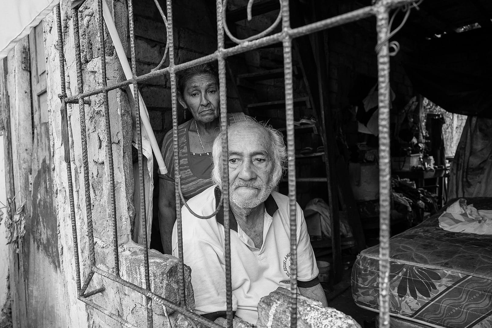 A couple behind window bars